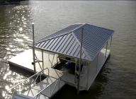 Single slip all aluminum floating dock with blue roof