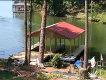 Double slip dock stationery w/ two boatlifts, metal gable roof with swim platform on Lake Jackson, GA